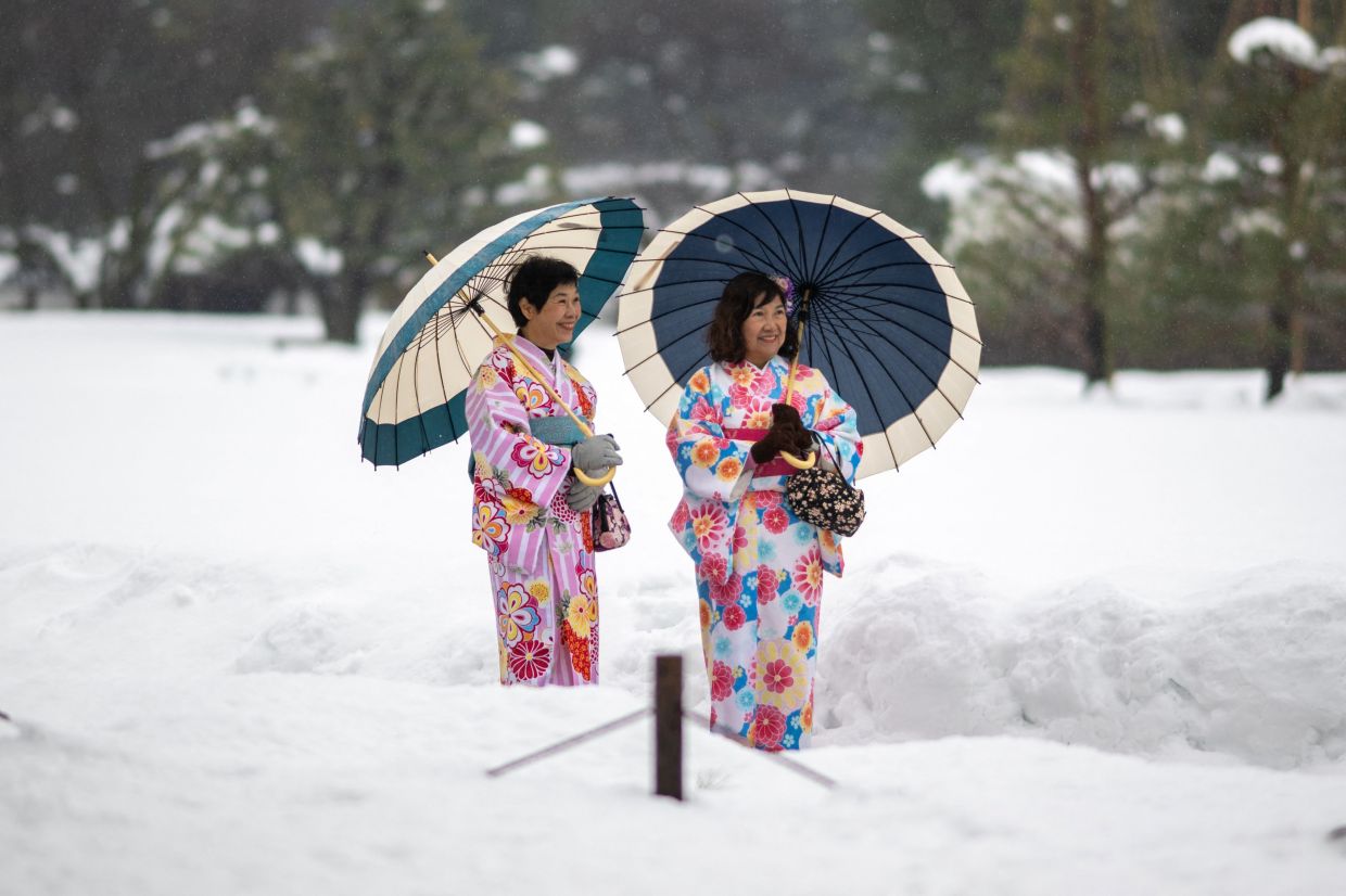Tourists in traditional outfits visit the snow-covered Kanazawa Castle in Kanazawa, Ishikawa Prefecture, on Tuesday, January 27, 2026. -- Photo by Philip FONG / AFP
