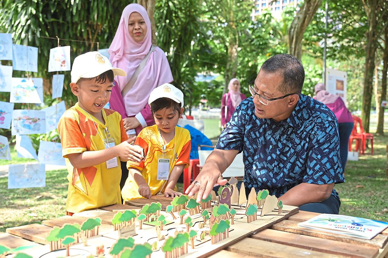 Mohamad Zahri spending time with some of the children who are part of MBPJ’s pilot project on environmental education for the young.