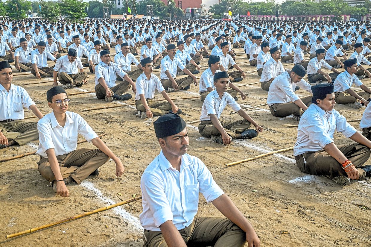 Volunteers for the far-right nationalist Rashtriya Swayamsevak Sangh listen to a speech at a celebration of the groupÕs centenary in Nagpur, India on Oct. 2, 2025. With Prime Minister Narendra Modi at the helm of India, the century-old RSS is closing in on its dream of a muscular, Hindu-first nation. (Atul Loke/The New York Times)