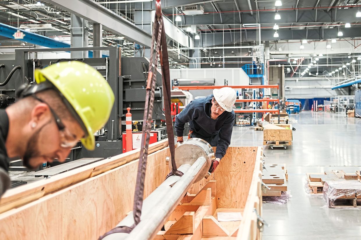 Workers moving a large component at the Kairos Power campus. — Ramsay de Give/The New York Times