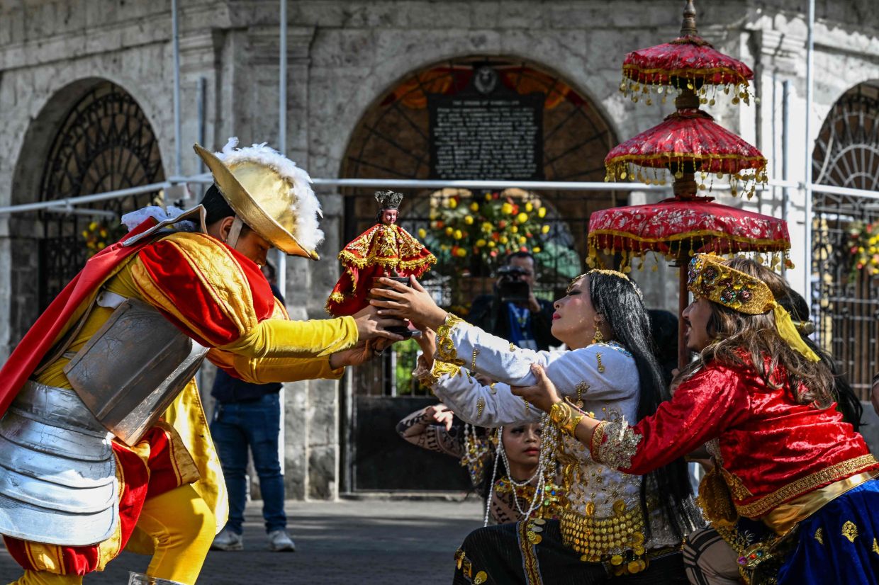 Performers taking part in a reenactment of the arrival of the Magellan's Cross, now a religious and pilgrimage site that commemorates the foundation of the Christian faith, in Cebu on Jan 28, 2026. - AFP
