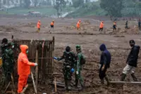 Search for 32 people missing in Indonesia landslide hampered by rain as death toll rises to 34