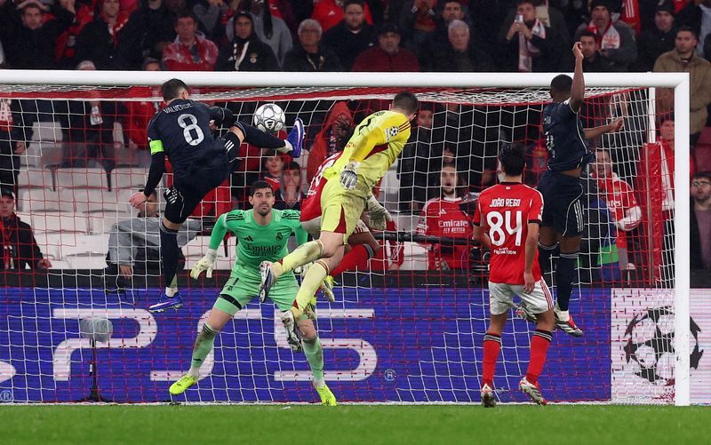Soccer-Goalkeeper scores at death to keep Benfica in Champions League with 4-2 win over Real Madrid