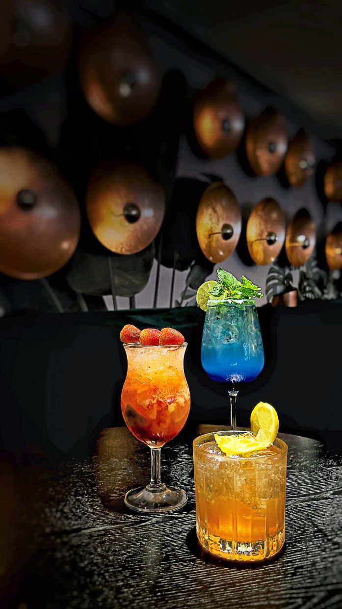 (Clockwise from top) Blue Sea, Jungle Bird, and Strawberry Caipiroska are some of the festive cocktails At 137 Bar.