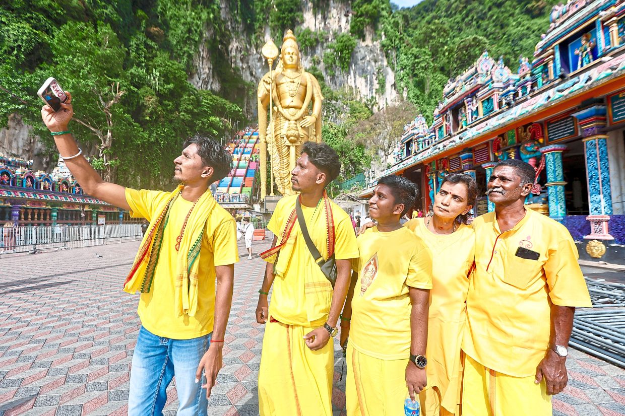 Letchumanan (right) with (from left) Thanesh, Darwin, Deevesh and Mahaletchumy visiting Batu Caves for the first time.