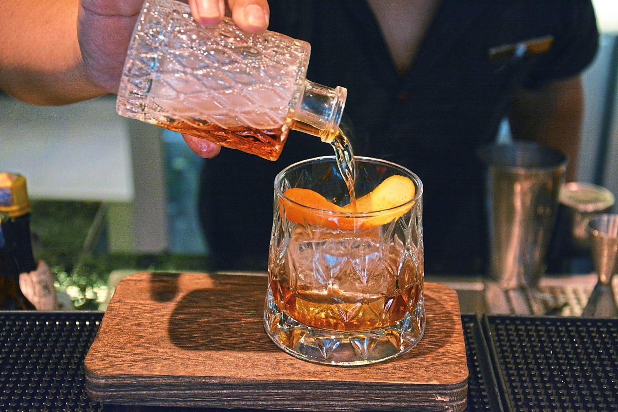 A mixologist assembling the Jazzy Boozy Boogie.