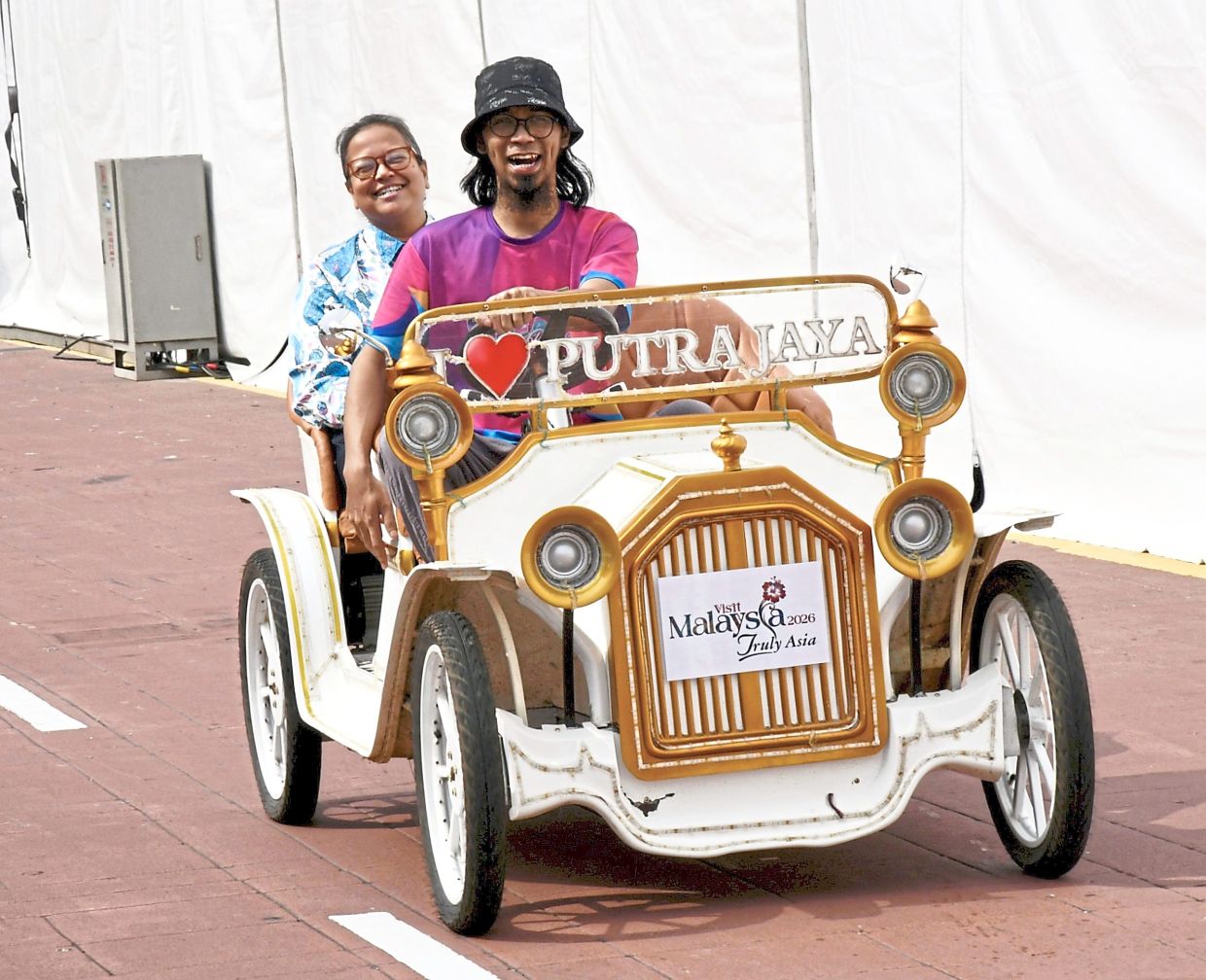 Hold on to your seats: Visitors at the Putrajaya Open Day 2026 enjoying a fun ride.