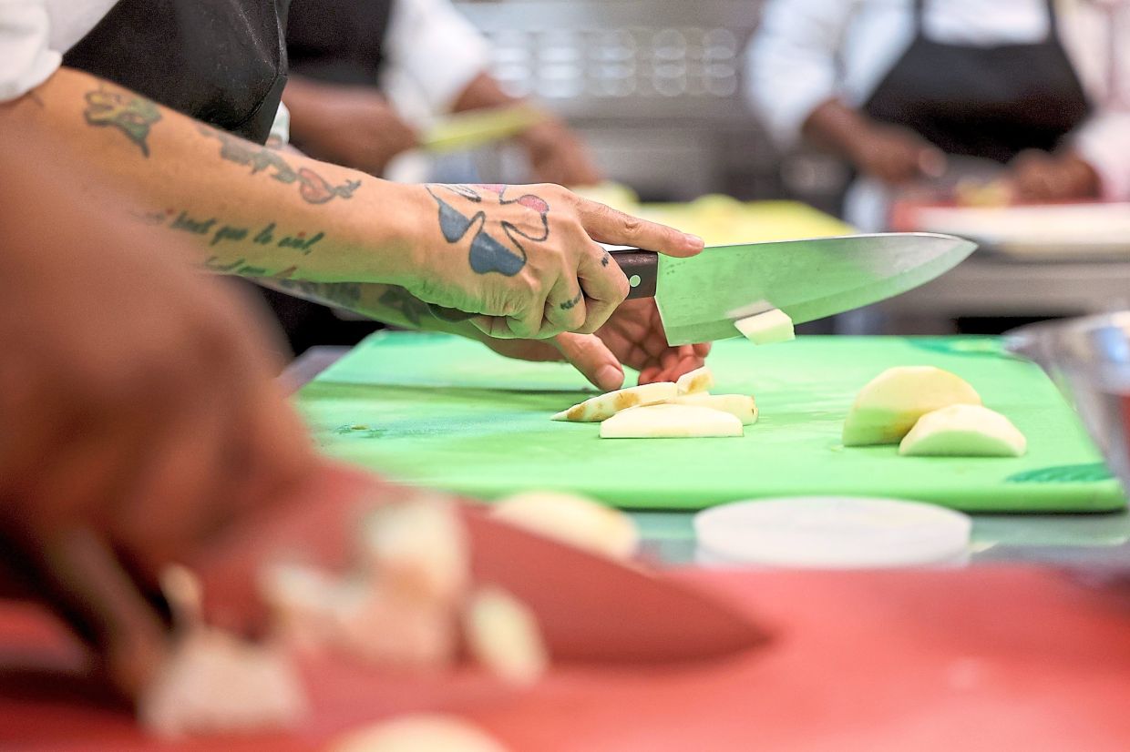 Shortoff cuts apples at Inspiration Kitchens.
