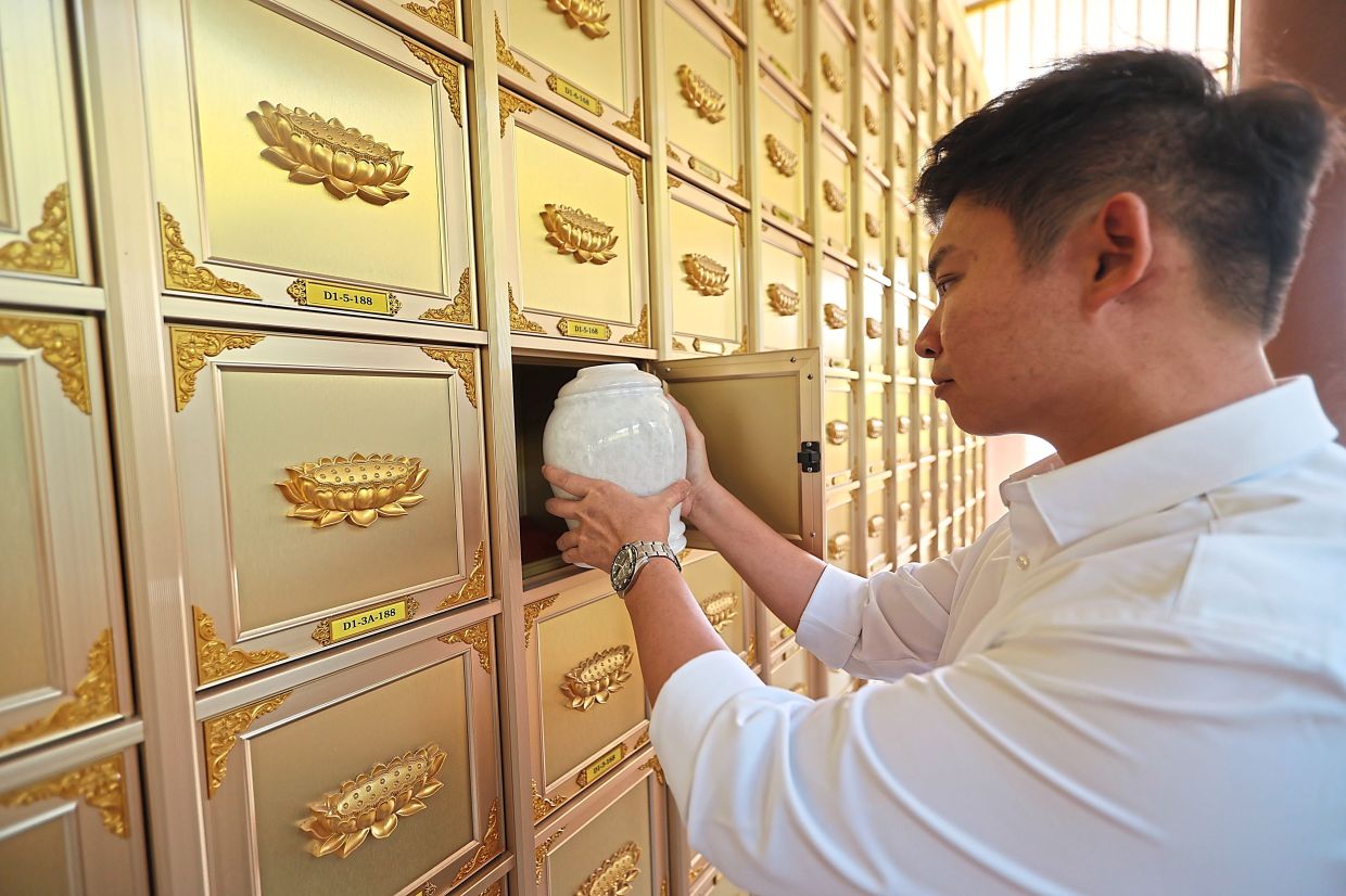 Tan at Universal Memorial Park in Semenyih, Selangor, where some of the ashes of unclaimed bodies are kept in niche urns. If the deceased’s identity is unknown, the niche is numbered. — LOW BOON TAT/The Star
