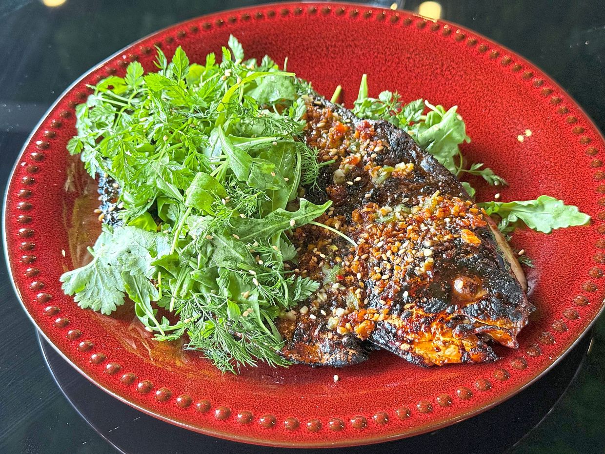 Smoky, sticky and sultry, the grilled pomfret is a fire-grilled star. — MICHAEL CHEANG/The Star