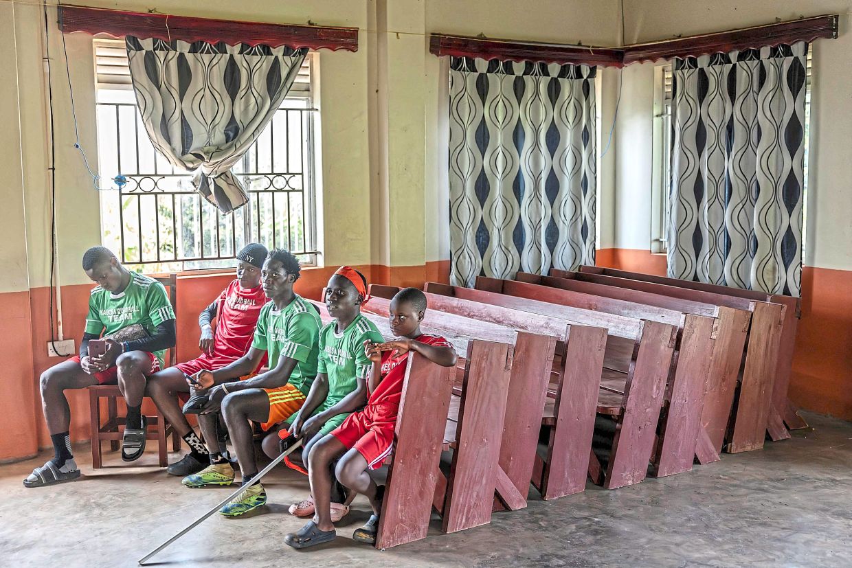 Players gather to discuss the game at a small community centre after a training session of Quidditch, also known as Quadball.