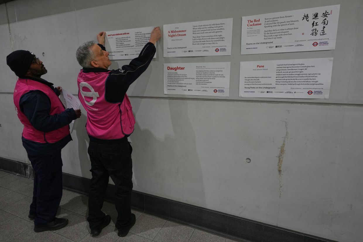 TFL ambassadors display poems at a gathering to celebrate 40 years of 'Poems on the Underground' in London. Photo: AP