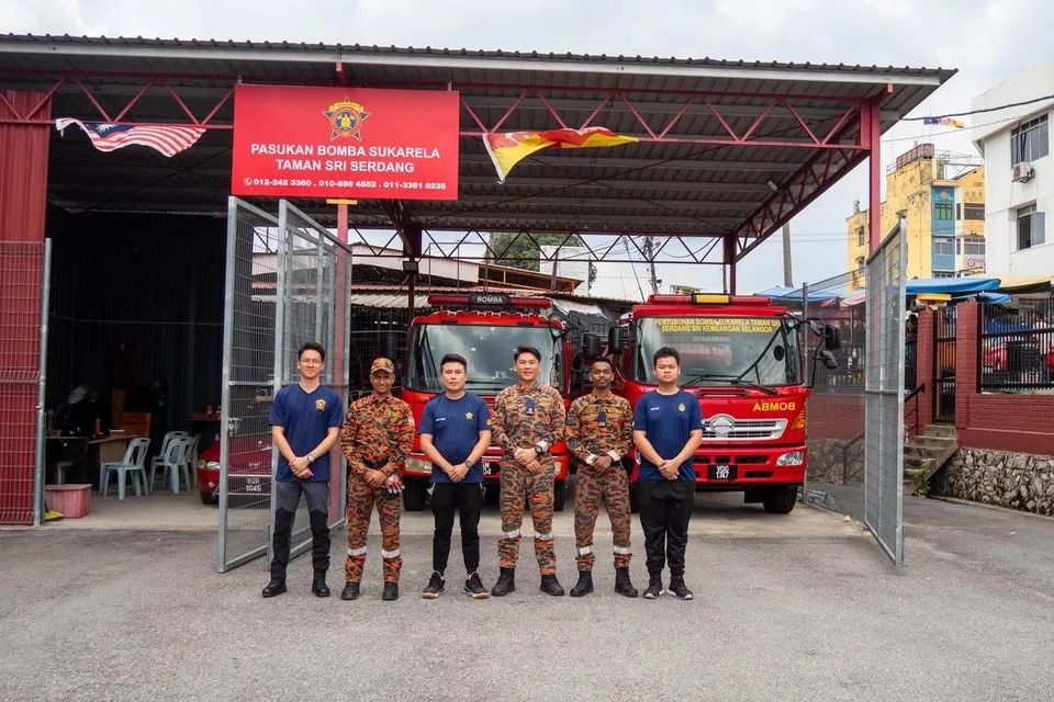 Scott Pang (third from right) and members of the Seri Serdang Volunteer Fire Association posing in front of the fire station where they are based. - Photo: Hadi Azmi