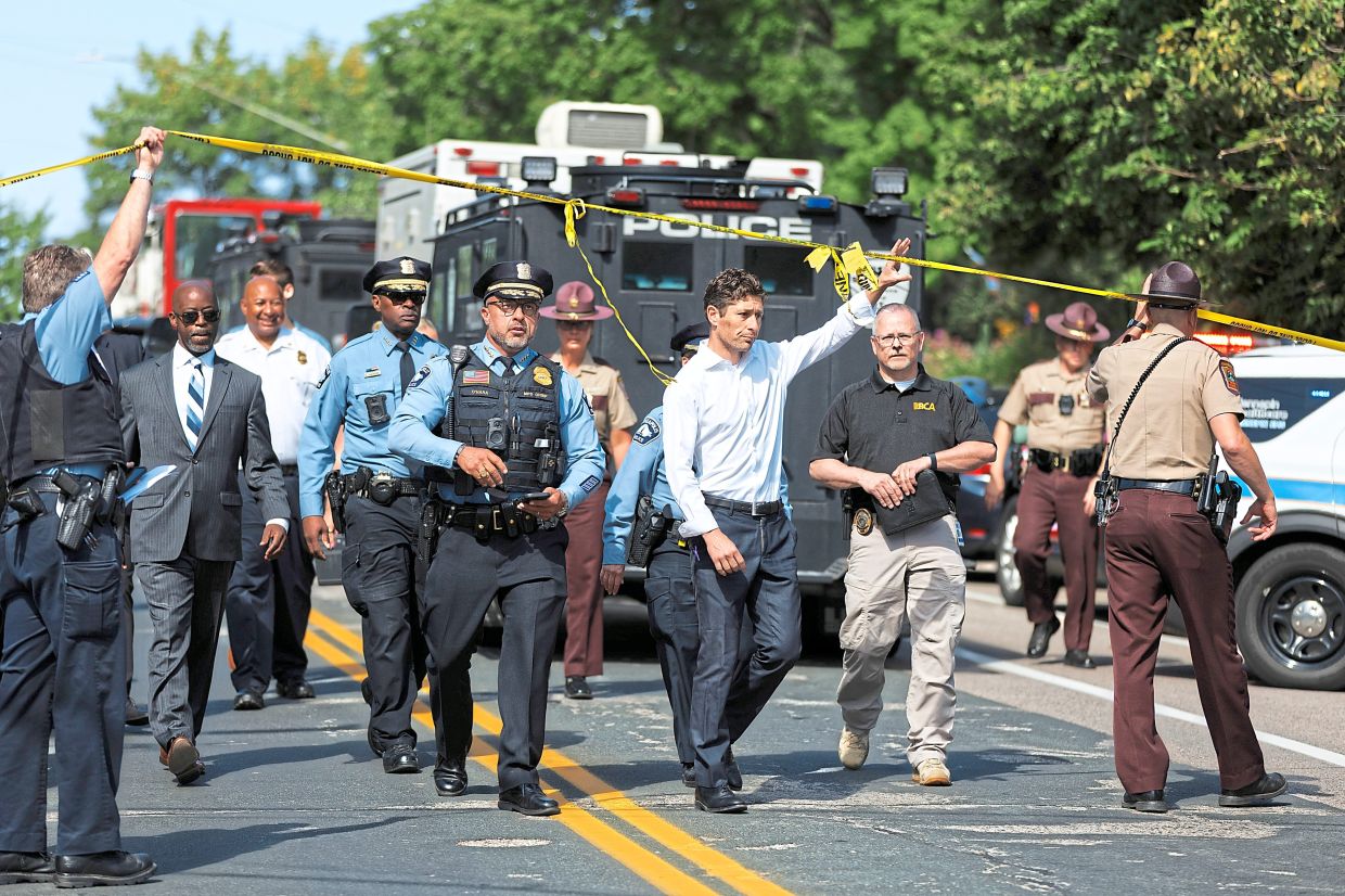 Frey (centre) walking with Minneapolis Police Chief Brian O’Hara (left) to a news conference near the scene of a shooting at the Annunciation Catholic Church in Minneapolis. — Liam James Doyle/The New York Times