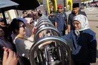 Queen greets tourists at entrance to Istana Negara