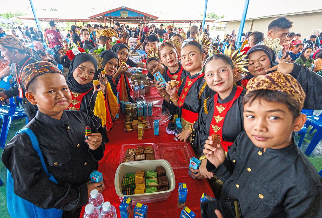 Villagers and visitors enjoying a communal feast during the Kaul Medong festival.