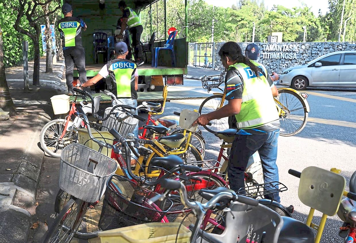 DBKL enforcement personnel carting off bicycles during an operation in Taman Tasik Titiwangsa in February 2024. — Courtesy photo