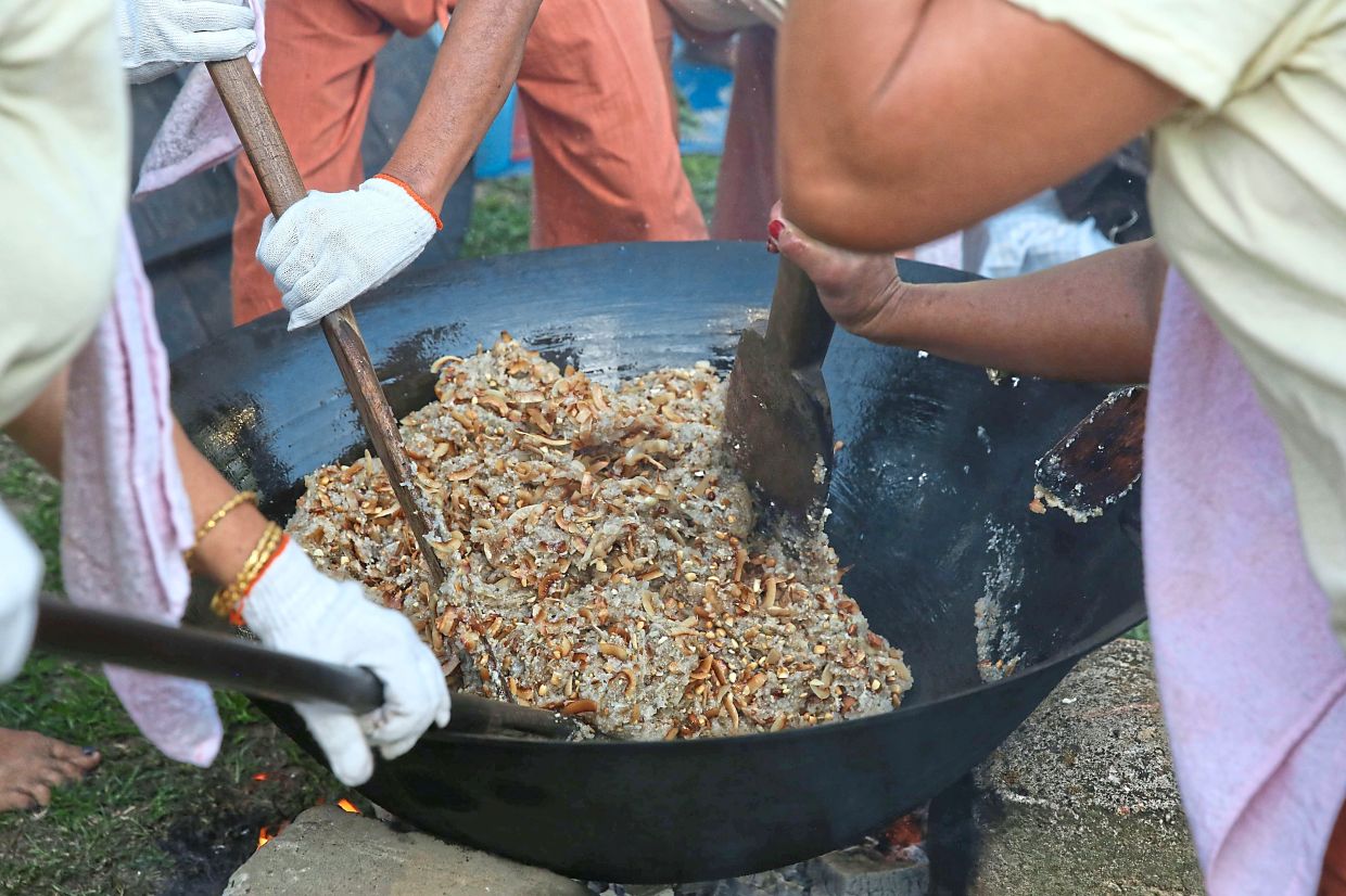 Htamane, the festival’s signature dish, is made from glutinous rice, sesame seeds, peanuts, coconut slices and ginger. — Xinhua