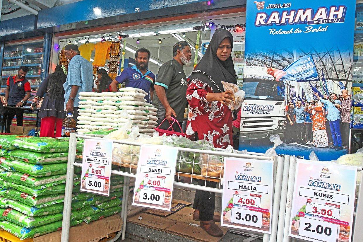 Customers shopping at the Rahmah sale at a sundry shop along Lebuh Chulia, in George Town, Penang.