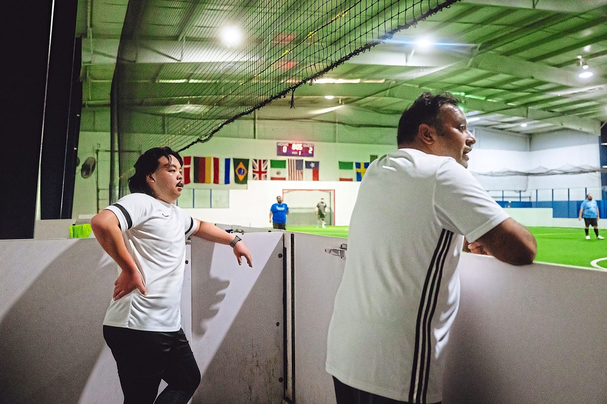 Totten-Ham and Cheese players watch their teammates during a match against Fat Man United.