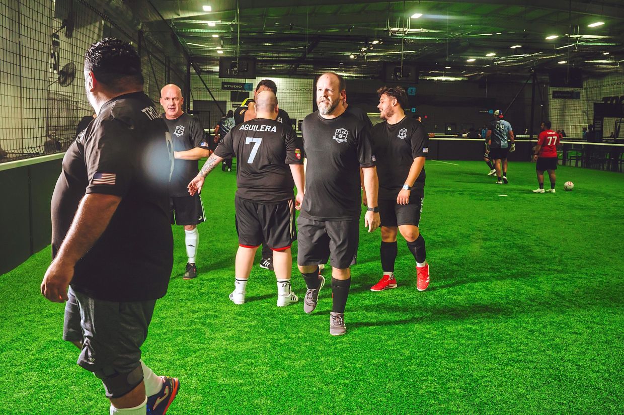 Fatty Liverpool Football Club players celebrate after winning against K-FC Dallas.