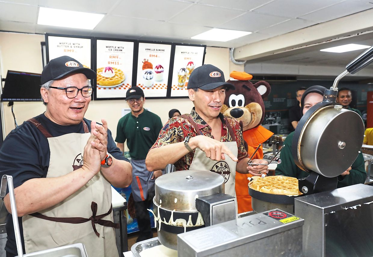 Khoo (right) and Ung competing in a waffle-making contest. 