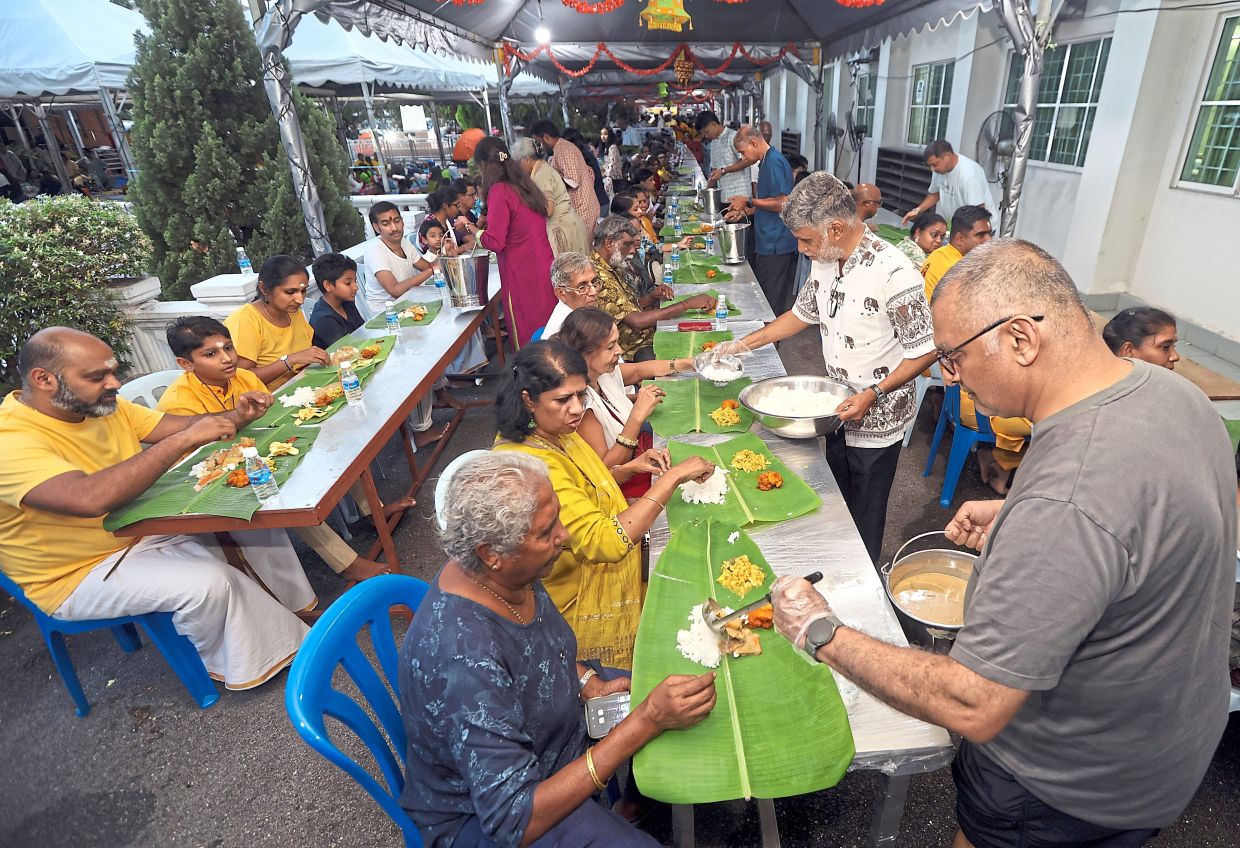 Food being served to devotees and visitors during Thaipusam at Sivananda Ashram in Batu Caves.— Photos: CHAN TAK KONG/The Star
