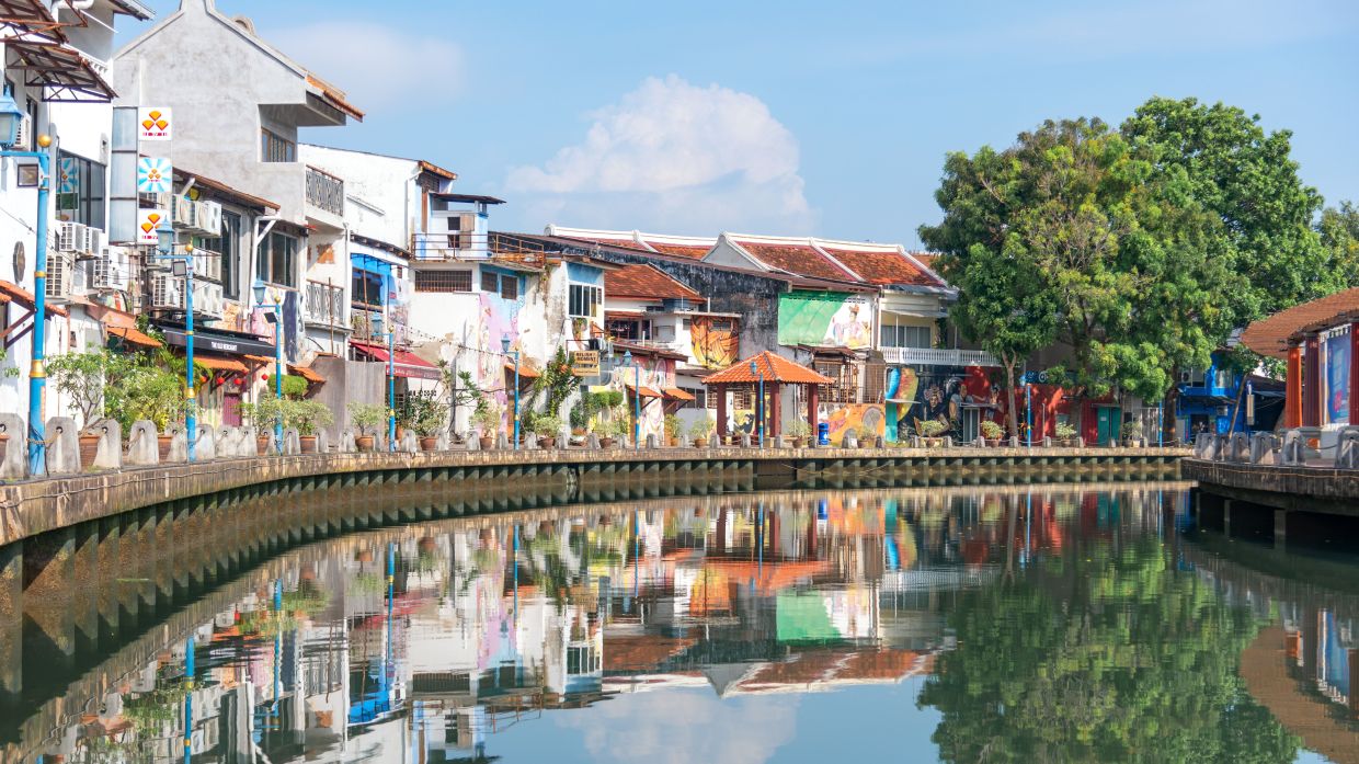 The tranquil Melaka River, lined with vibrant heritage buildings, provides a soothing backdrop for patients and families during their healing journey.