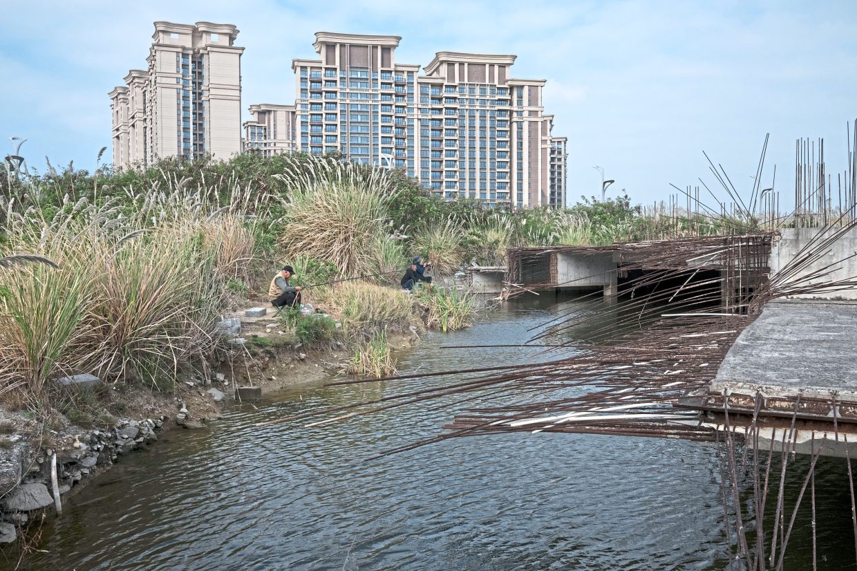Seniors fishing near high-rises on Island 2, the most built-out part of of Ocean Flower Island.