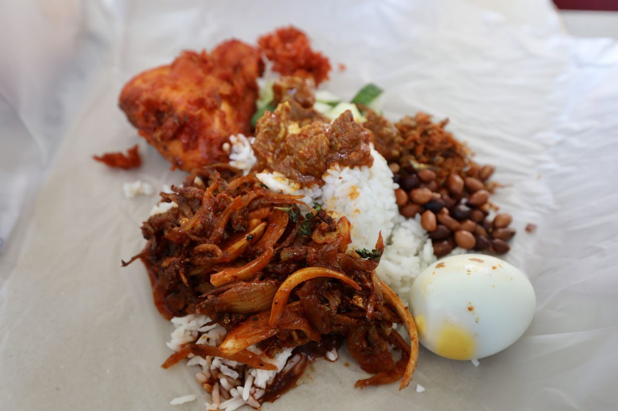 Sangeetha became incredibly popular for her personality and her delicious nasi lemak, served with all sorts of side dishes. — LOW LAY PHON/The Star
