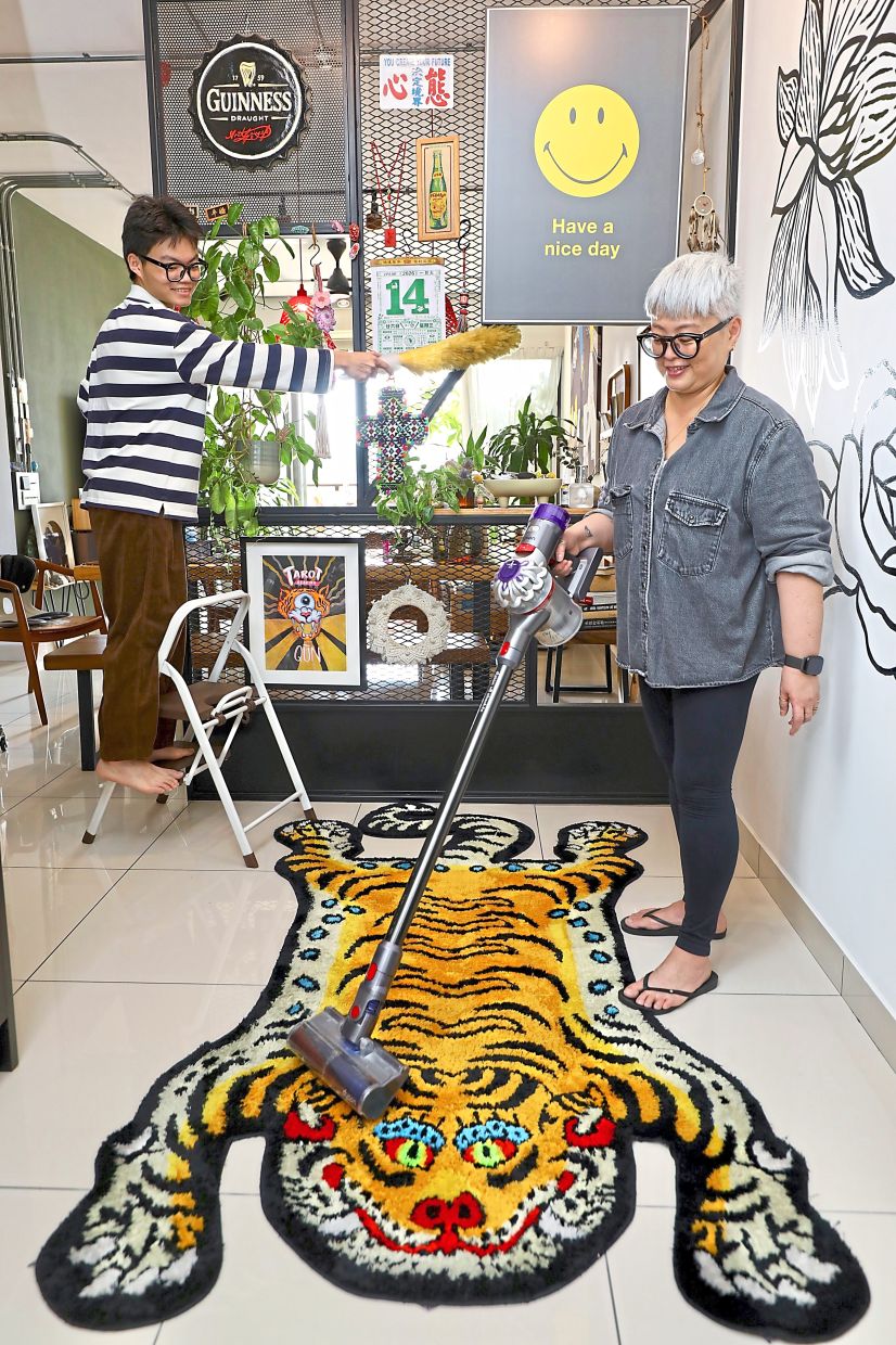 Liew (right), pictured with son Angus, says her children have daily responsibilities, and shared spaces are maintained together.