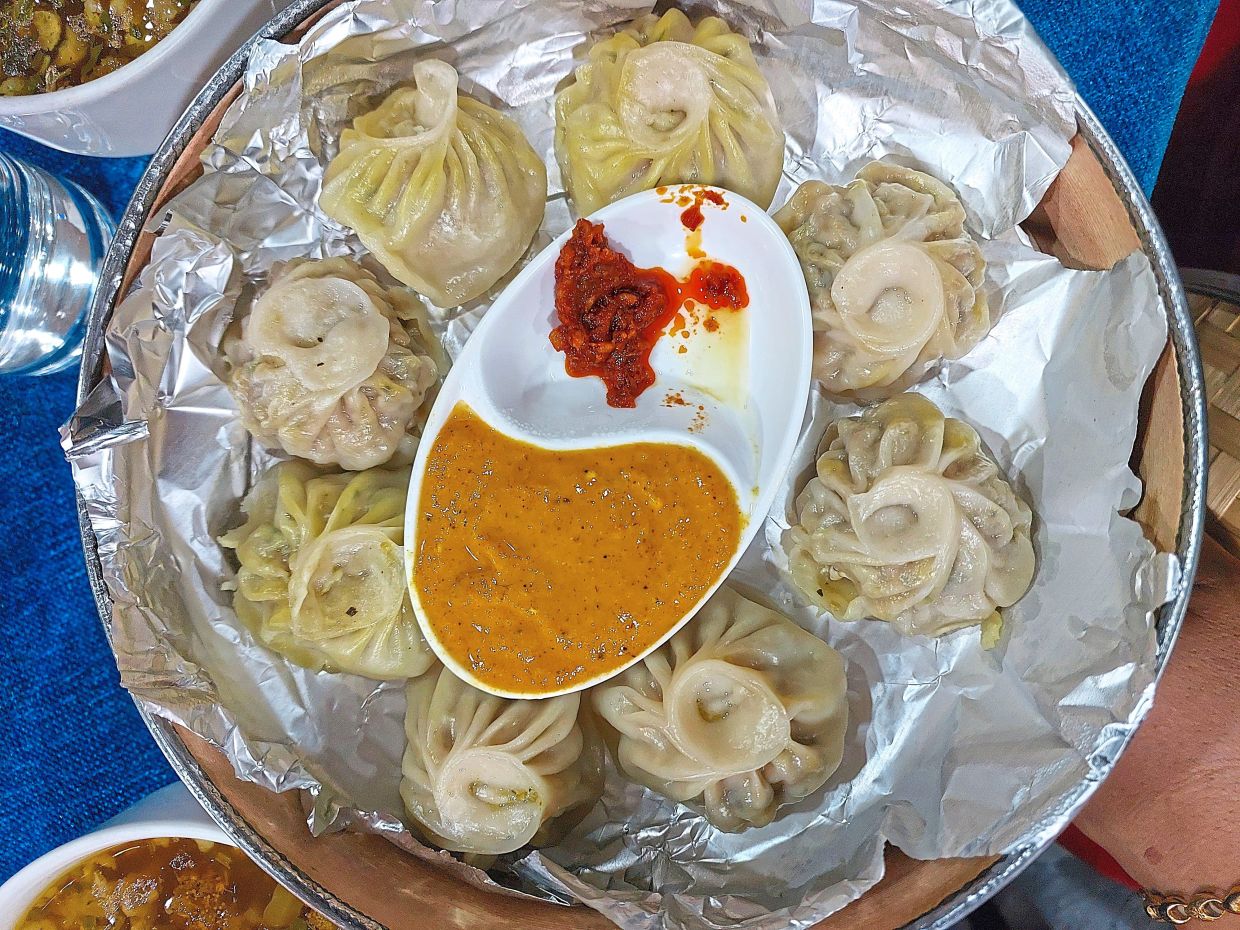 Momo in Nepal is usually served with achar, a tangy and spicy dipping sauce. — MELODY L. GOH/The Star