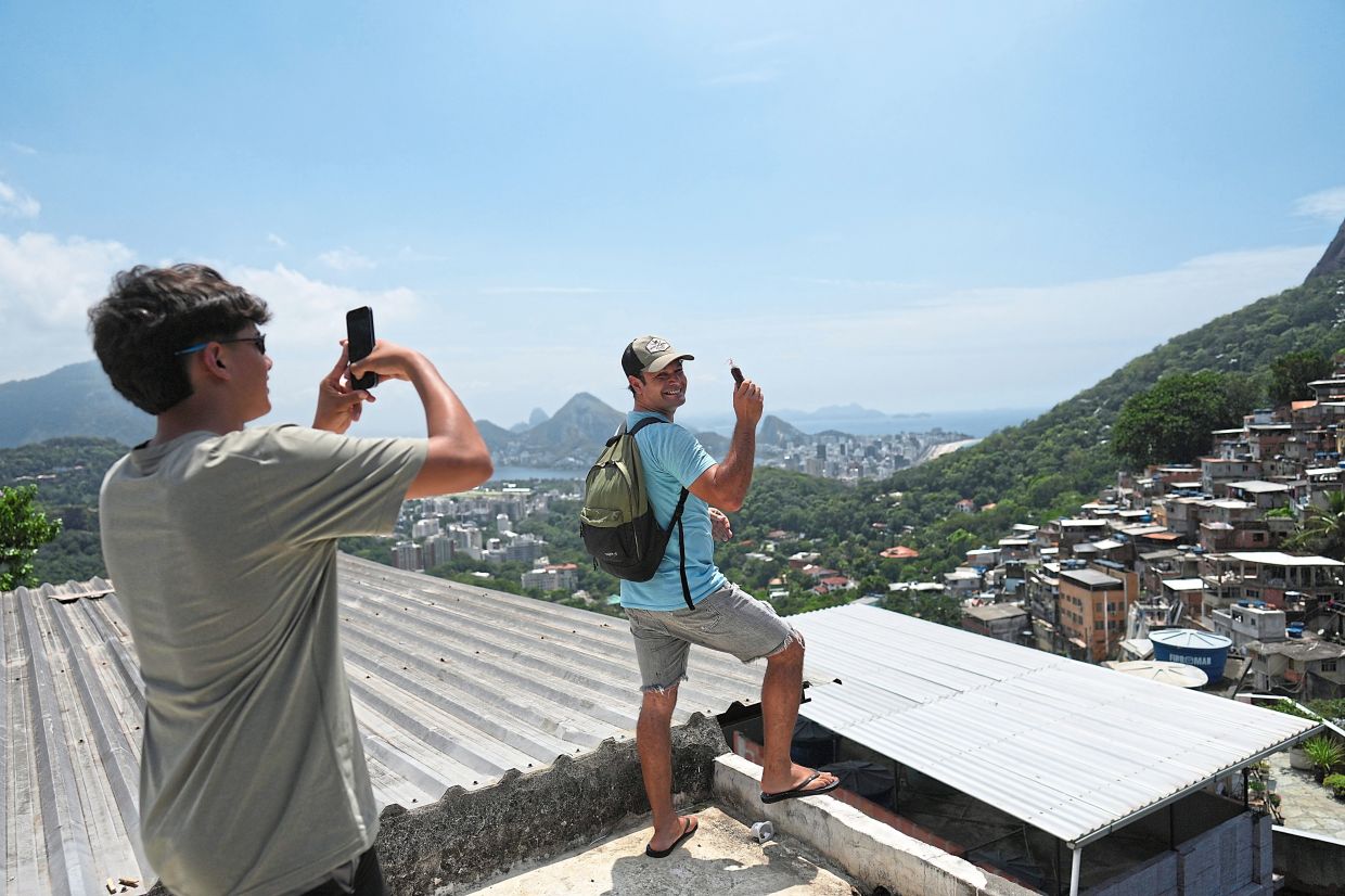 Jara posing for his nephew Jose Martinez on a rooftop in Rocinha.