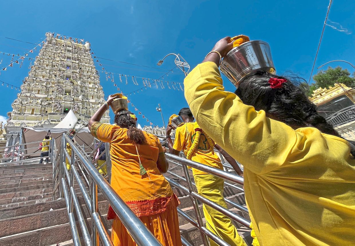 Devotees carrying milk pots to be offered to Lord Muruga.