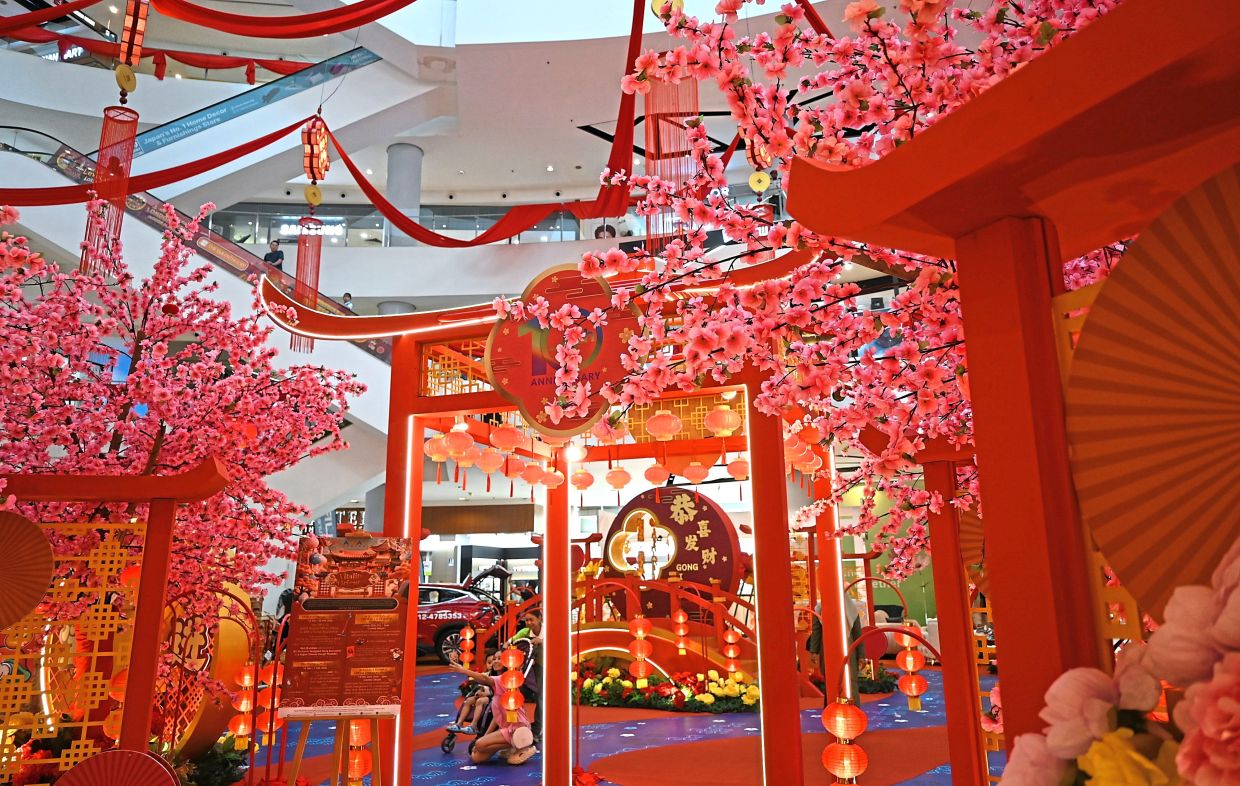 Intricate decorations and traditional elements creating a vibrant Chinese New Year atmosphere at the mall. 