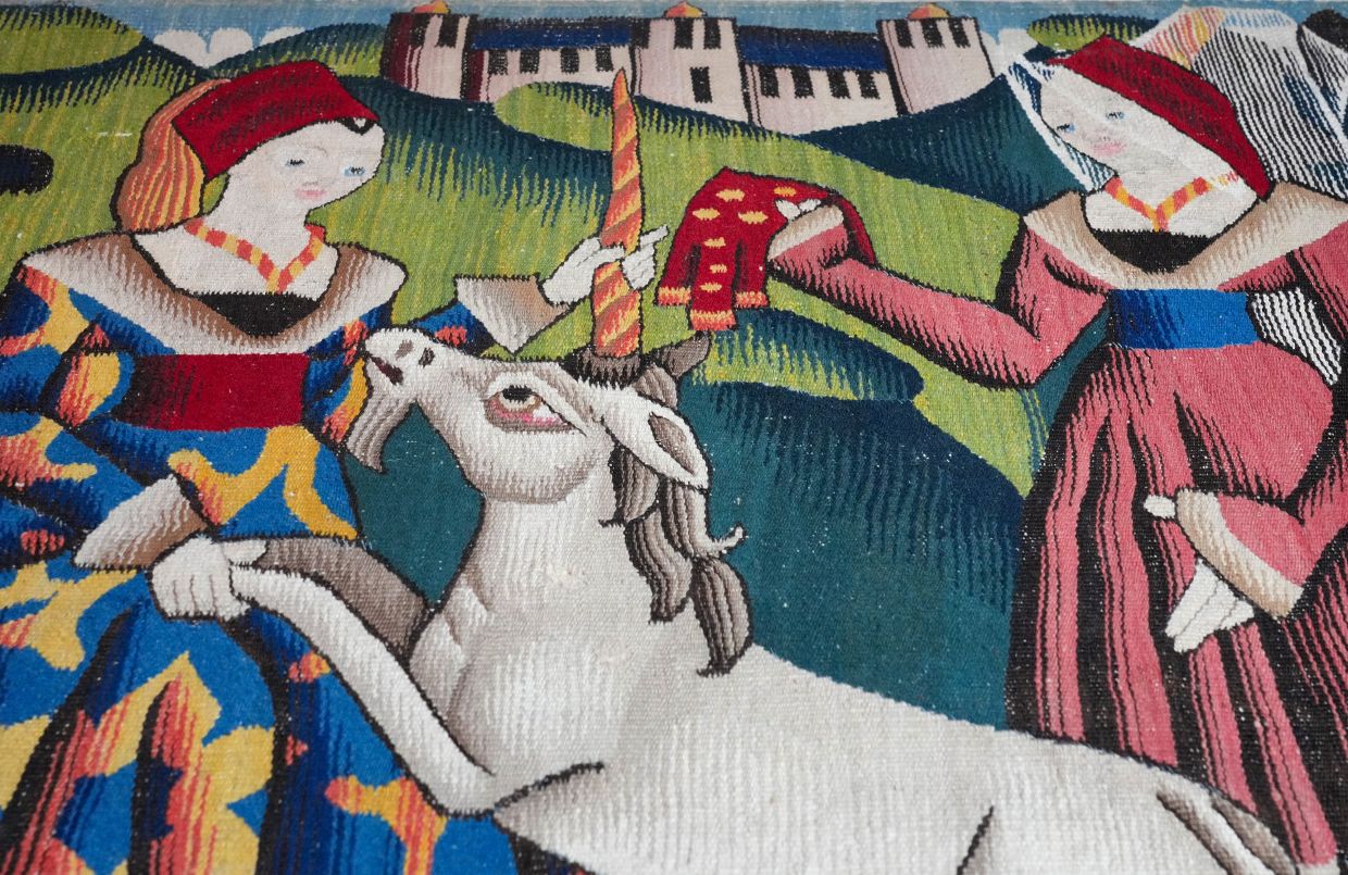 A tapestry (photo shows a section) from the 15th century lies on a work surface in St Gotthardt's Church in Germany. — Photo: Soeren Stache/dpa