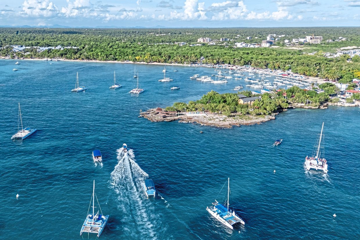 Boats manoeuvre off the coast of Bayahibe, Dominican Republic.