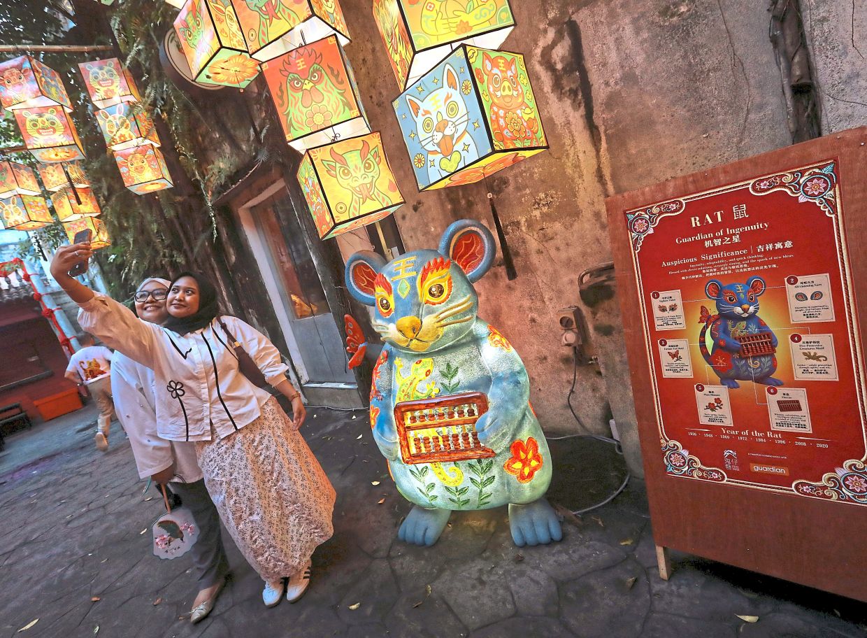 Each sculpture is accompanied by a poster detailing the meaning of its Zodiac animal and design elements. Photo: The Star/Azalina Abdullah