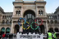 Olympics-Greenpeace stages protest in Milan as torch arrives in the city