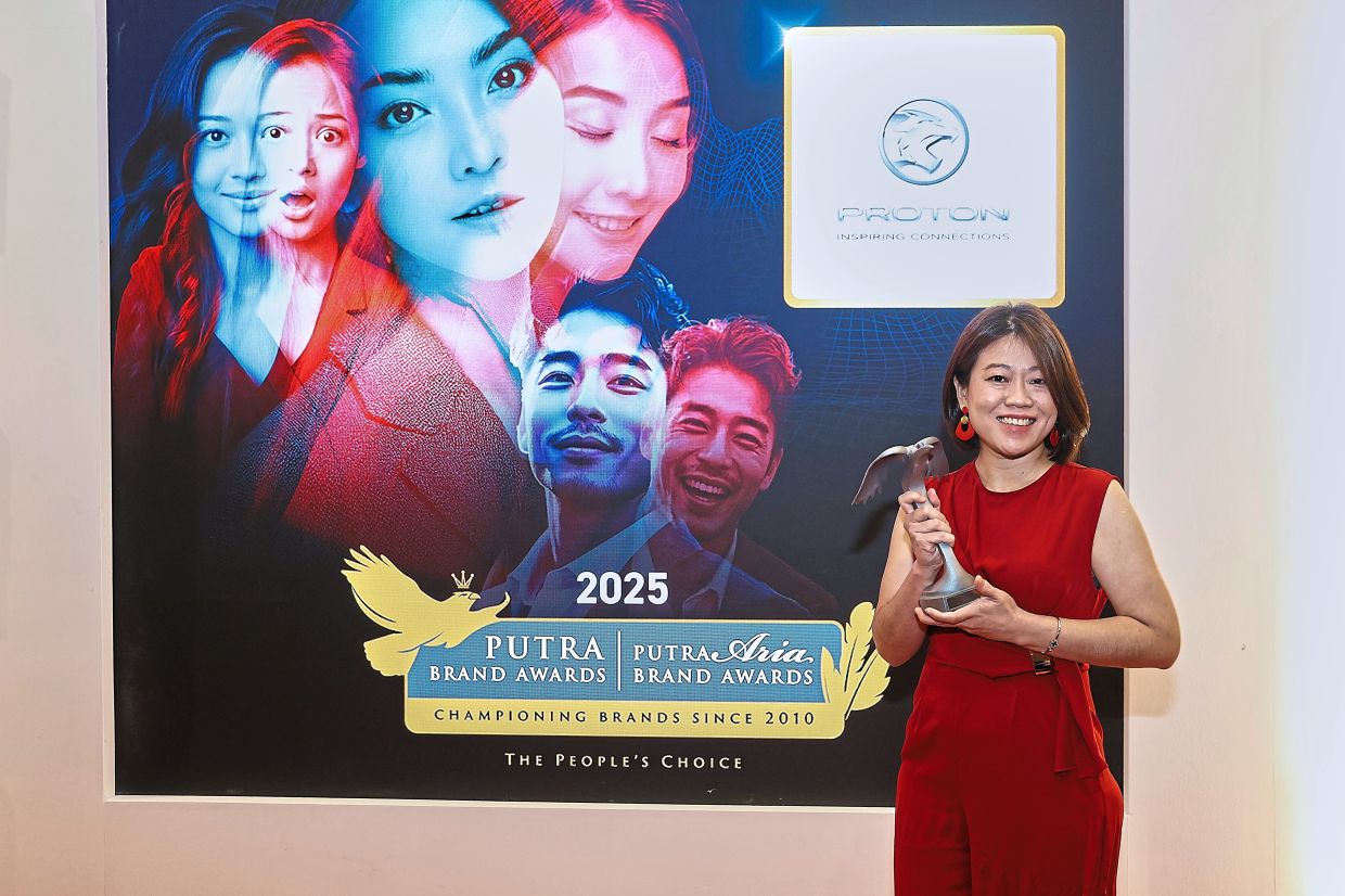 Proton branding head Too Woon Shim with the silver award for Automotive.