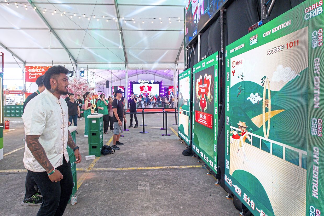 Visitors playing digital games during the CarlsCrib-CNY edition at 1Utama.