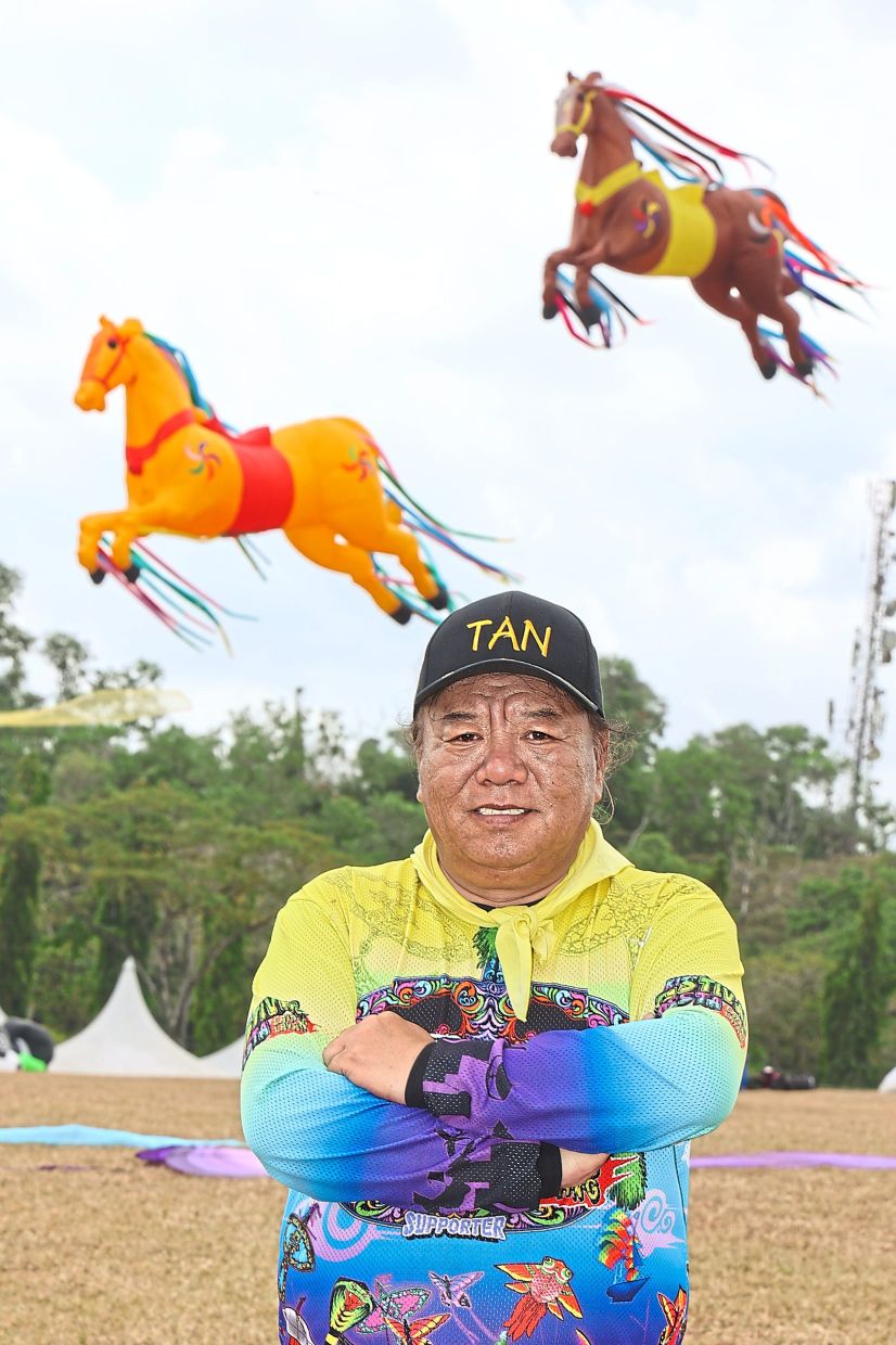 Culture on display: Tan with the horse kites flying behind him. — THOMAS YONG/The Star