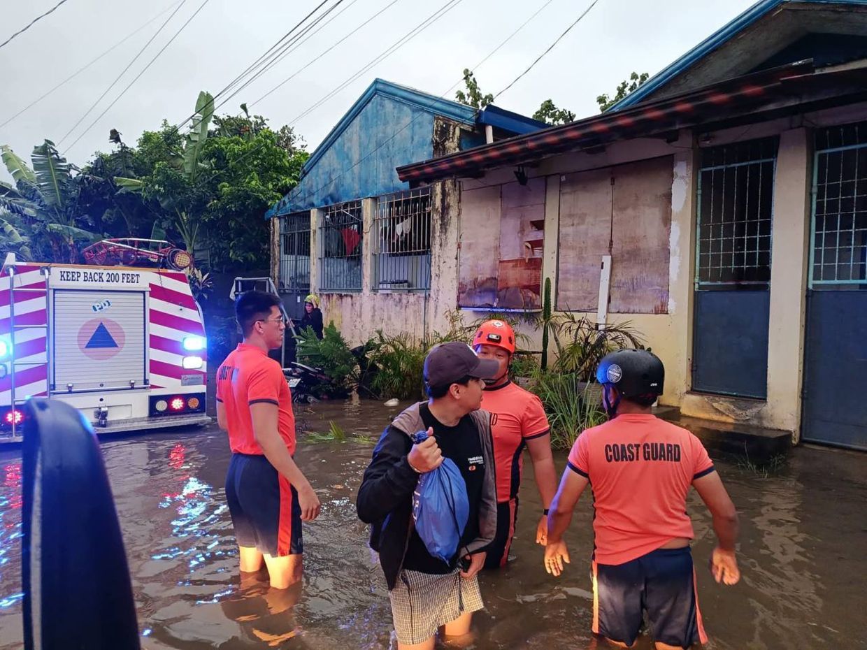 This handout provided by the Philippine Coast Guard shows rescuers wading along flooded streets as they relocate residents to higher ground after Tropical Storm Penha hit Surigao city, at the province of Surigao del Sur, southeastern Philippines on Friday, Feb. 6, 2026. -- Photo: Philippine Coast Guard via AP