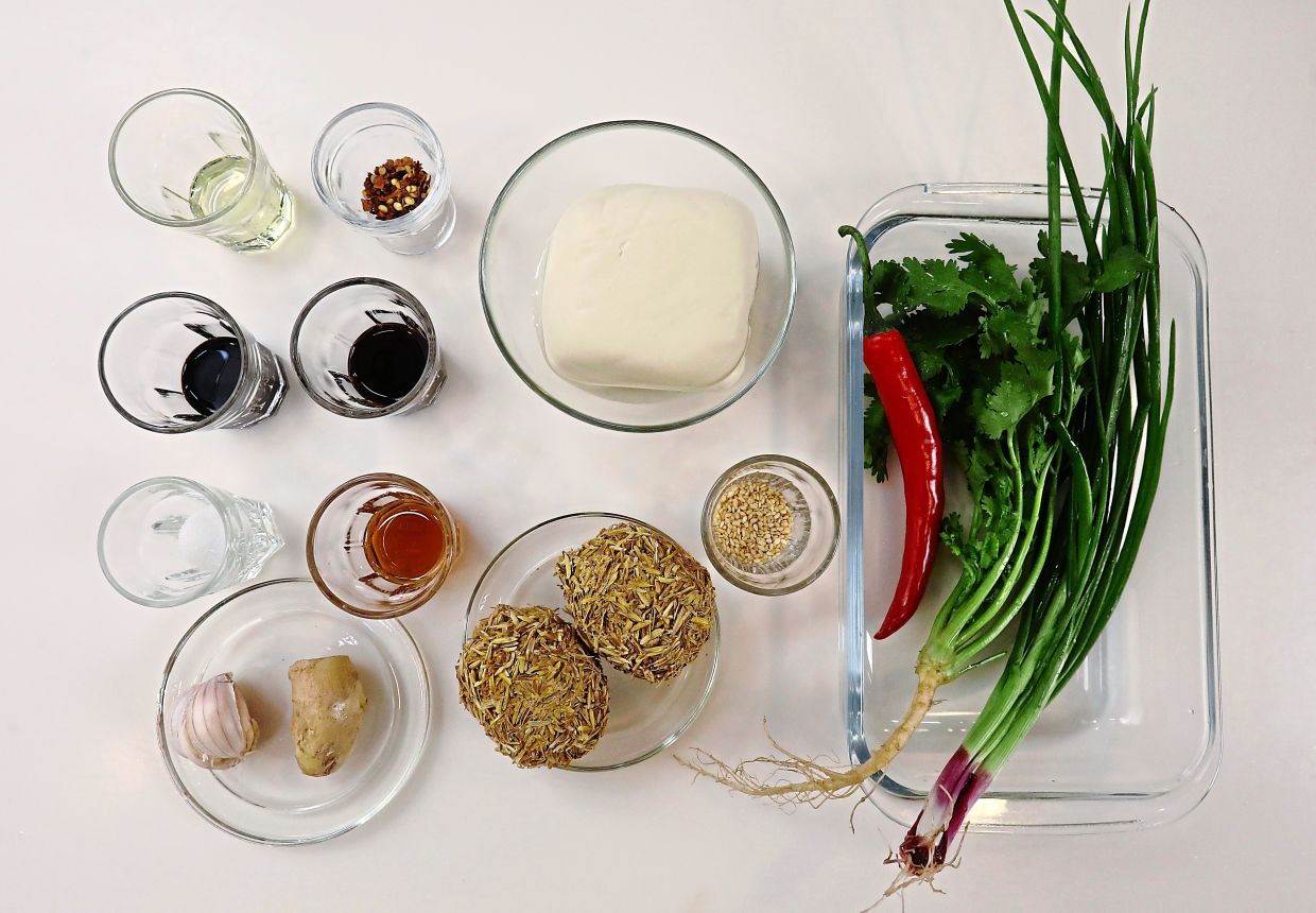 Traditional medium-soft tofu with a delicate skin is preferred if available fresh, but boxed silken tofu is a common alternative to create the dish.