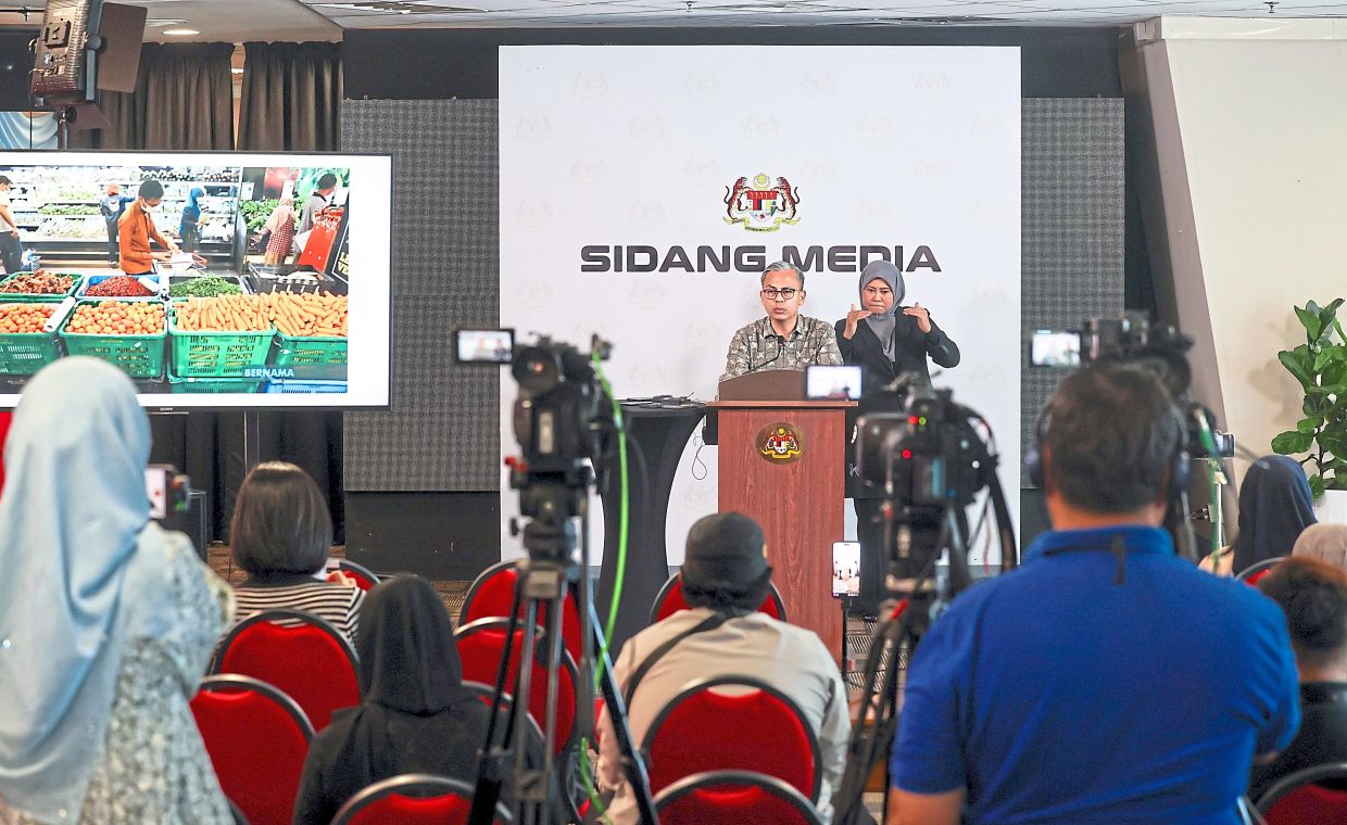 Sharing updates: Fahmi speaking at the weekly post-Cabinet press conference in Putrajaya. — Bernama