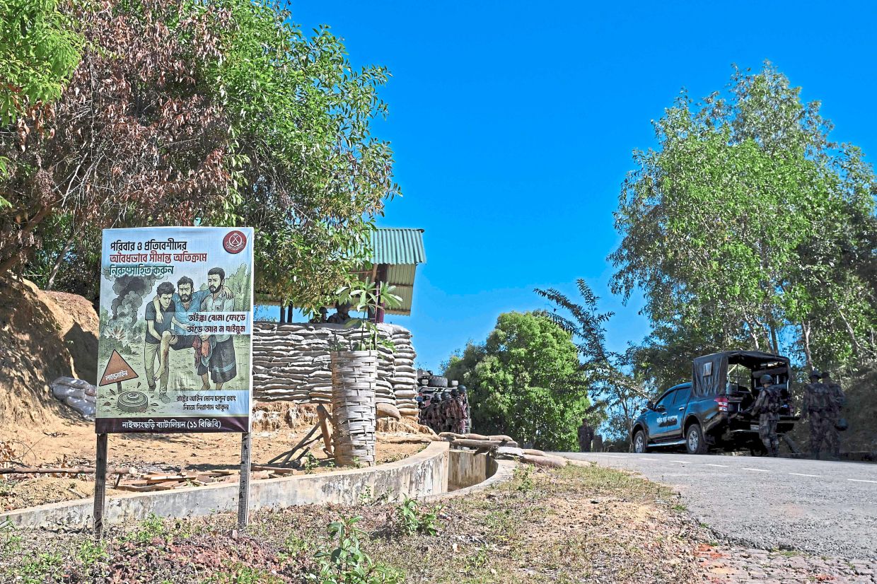 A landmine cautionary signboard set up by the Border Guard Bangladesh (BGB) personnel at a checkpoint in the Bangladesh-Myanmar frontier district of Bandarban. (Right) Ali Hossain, who lost his leg to a landmine while collecting firewood, leaning on a crutch as he walks home at the Bangladesh-Myanmar frontier village of Naikhongchhari in Bandarban district. — AFP