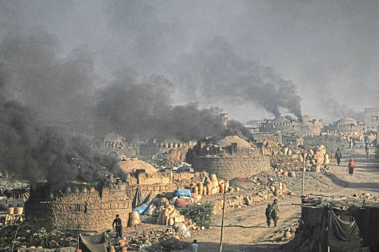 Smoke billowing from kilns at a potters’ colony in Karachi. With pollution in Pakistan hitting record highs in recent years, citizens clutching air monitors and legal papers are taking the fight for clean air into their own hands. — AFP