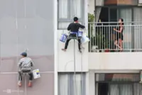Vietnam's Ho Chi Minh City rope workers brave heights to clean and repaint skyscrapers for Tet festival