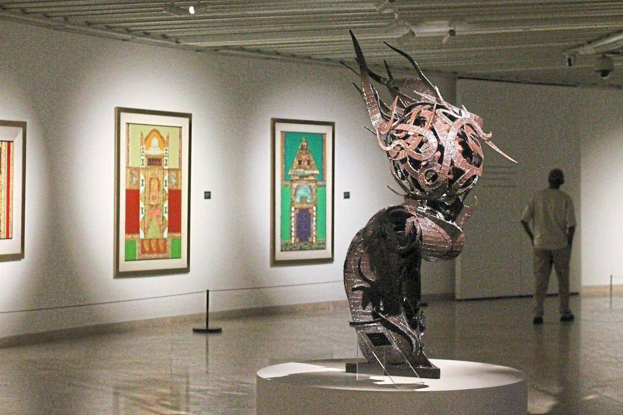 Mad Anuar Ismail's 'Kencana' (2025) is a combination of metal and wood that depicts Arabic characters bent into a circular shape on an ocean wave. Photo: The Star/ M. Irsyad 