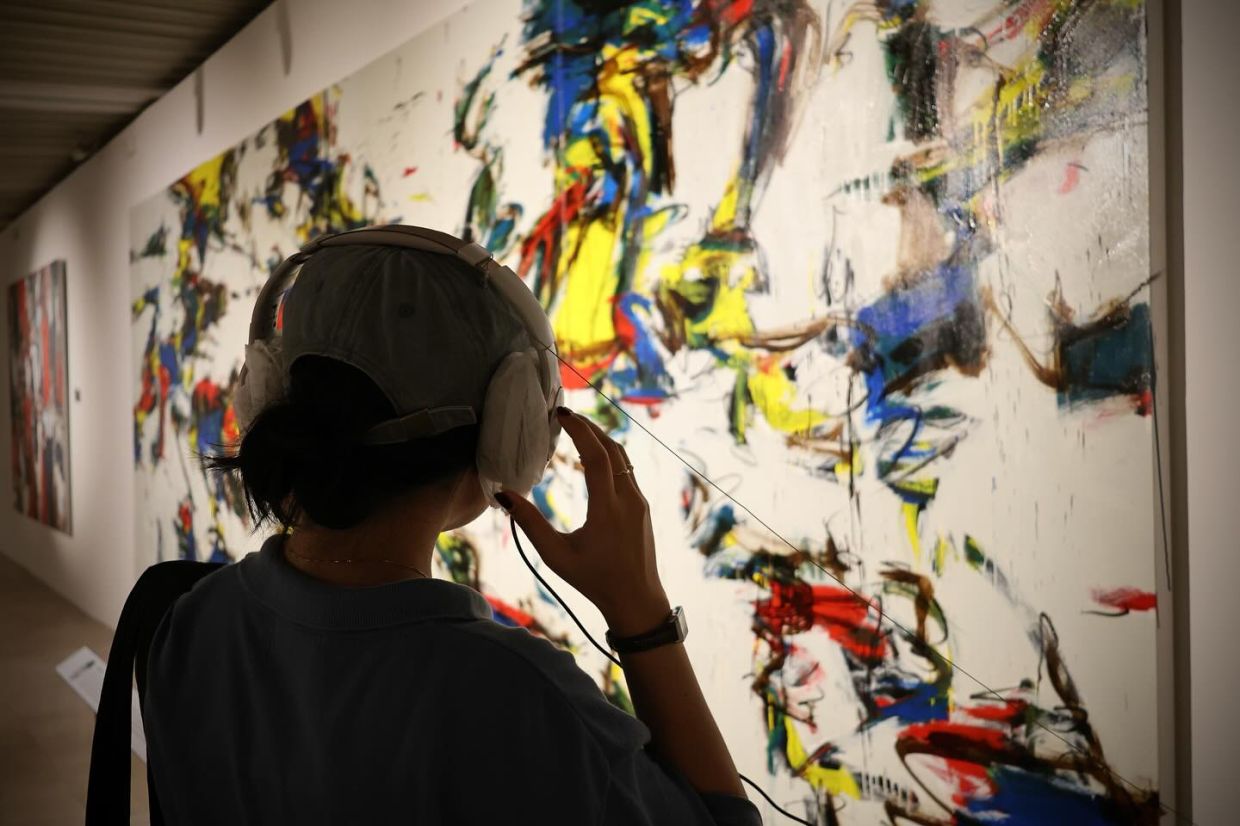 The 'What Song Do You Hear When You See This Painting?' exhibition explores the relationship between art and music, with headphones and speakers playing pieces linked to the artworks. Pictured is Suzlee's abstract painting 'Growth' (2025). Photo: Galeri PETRONAS